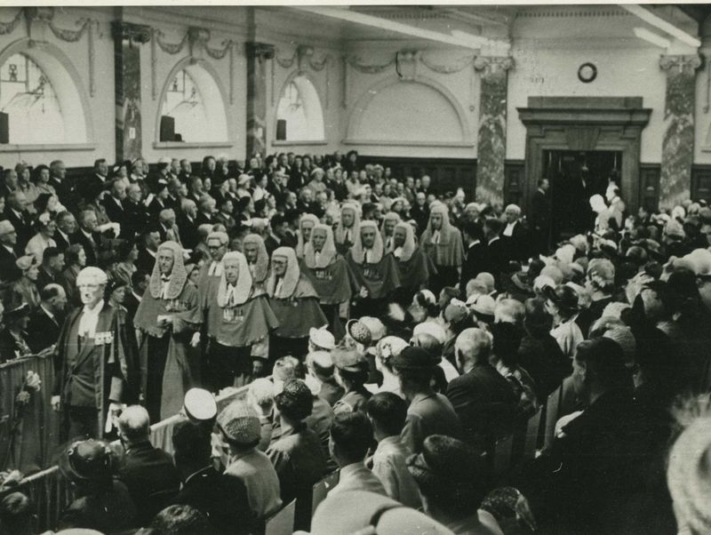 Inside Parliament now, Walter still out in front at far left, leading the judges through the packed hall